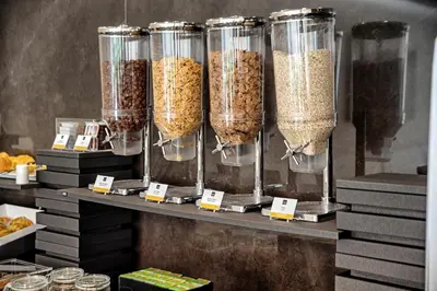 a shelf with several containers of cereals at ABC Hotel Porto - Boavista in Porto
