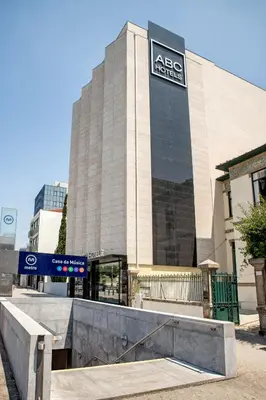a building with a sign on the side of it at ABC Hotel Porto - Boavista in Porto