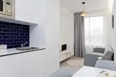 a kitchen with a sink and a living room at My Modern Homey at Porto in Porto