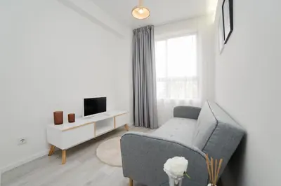 a living room with a couch and a tv at My Modern Homey at Porto in Porto