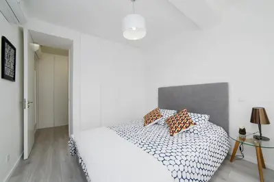 a white bedroom with a bed with pillows on it at My Modern Homey at Porto in Porto