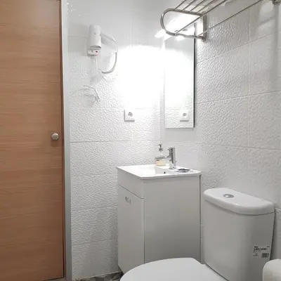 a bathroom with a toilet and a sink and a mirror at À Francos Metro in Porto