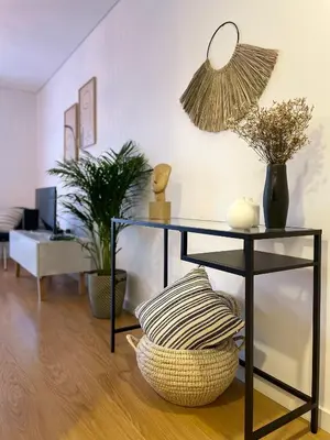 a living room with a table with a basket and plants at FT'Studio in Porto