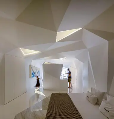 a room with white walls and a geometric ceiling at LeBlanche in Porto