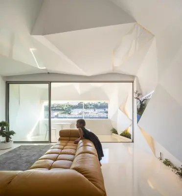 a person sitting on a couch in a living room at LeBlanche in Porto