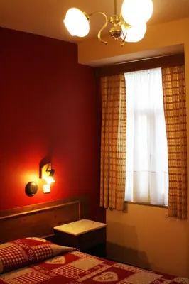 a bedroom with a bed and a window at Duas Nações Guest House in Porto