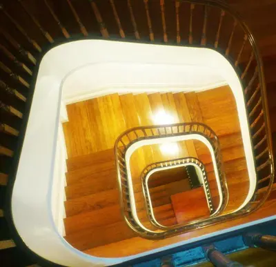 anorthole view of a stairwell in an airplane at Duas Nações Guest House in Porto