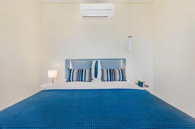 a white dining room with a white table and chairs at Trindade Modern Flat (with Air Conditioning) in Porto