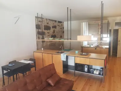 a kitchen and living room with a couch and a table at Step In Porto Apartments in Porto
