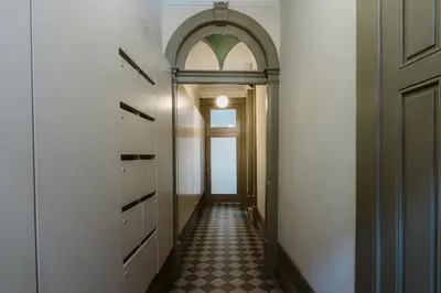 a hallway with a door and a tile floor at Step In Porto Apartments in Porto