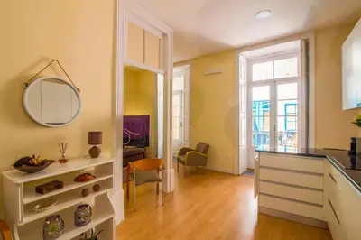 a kitchen with a sink and a mirror on the wall at São Domingos Flowers Apartments in Porto
