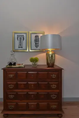 a wooden dresser with a lamp on top of it at Rosario's Boutique Apartments in Porto