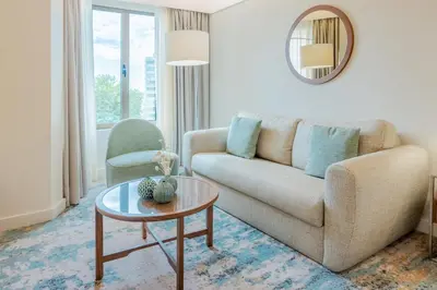 a glass desk with a lamp and a chair at Crowne Plaza Porto by IHG in Porto