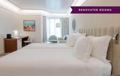 a hotel room with a large bed and a desk at Crowne Plaza Porto by IHG in Porto