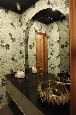 a bathroom with a sink and a flowery wallpaper at Hotel America in Porto
