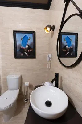 a bathroom with a sink and a toilet and a mirror at Hotel America in Porto