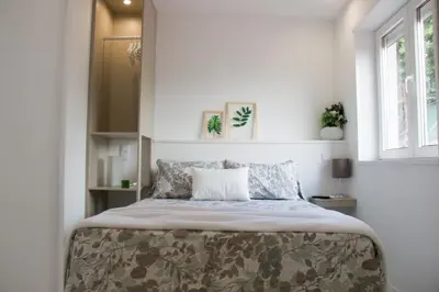 a bedroom with a bed with a pillow on it at Casa d'Avó in Porto