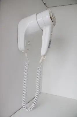 a white telephone hanging on a wall at Casa d'Avó in Porto