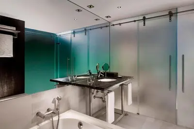 a bathroom with a sink and a mirror at Sheraton Porto Hotel & Spa in Porto