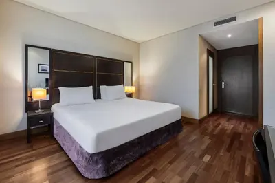 a large white bed in a hotel room at Eurostars das Artes in Porto
