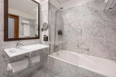 a bathroom with a tub and a sink and a shower at Eurostars das Artes in Porto