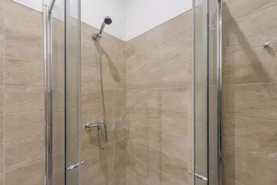 a shower with a glass door in a bathroom at GuestReady - Feels like Heaven in Porto