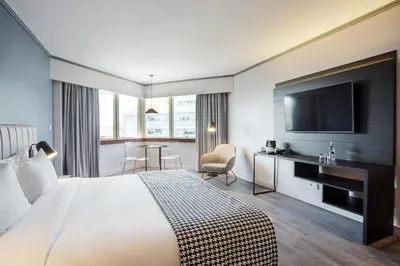 a hotel room with a bed and a flat screen tv at HF Fénix Porto in Porto