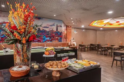 a buffet in a restaurant with a table of food at HF Fénix Porto in Porto