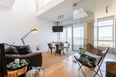 a living room with a couch and a table at CM Antas Studios in Porto