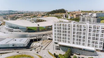 an aerial view of a large white building at CM Antas Studios in Porto