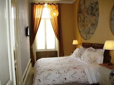 a bedroom with a white bed and a window at Pedra Iberica in Porto