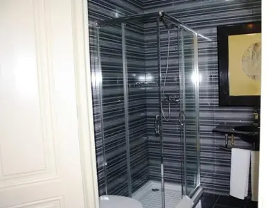 a bathroom with a glass shower with a toilet at Pedra Iberica in Porto