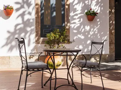 a table and two chairs and a table and two plants at Pedra Iberica in Porto