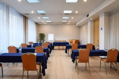 a conference room with blue tables and chairs at TRYP by Wyndham Porto Centro Hotel in Porto