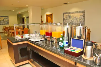 a restaurant with a counter with drinks in test tubes at TRYP by Wyndham Porto Centro Hotel in Porto