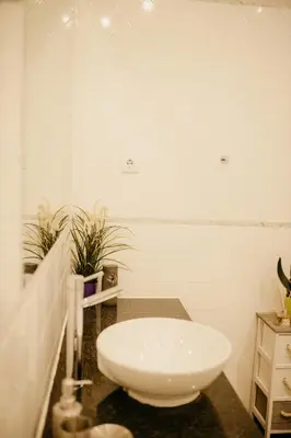 a bathroom with a white sink in a room at H.ö.H in Porto
