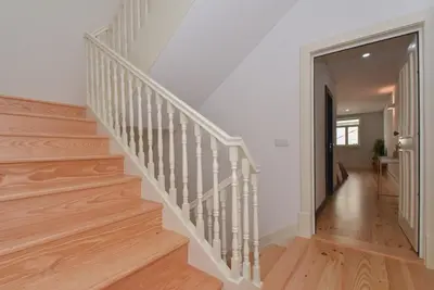 a staircase in a home with white walls and wood floors at Oporto Cool - Fontainhas in Porto