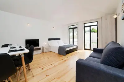 a room with a bed and a couch and a table at Oporto Cool - Fontainhas in Porto