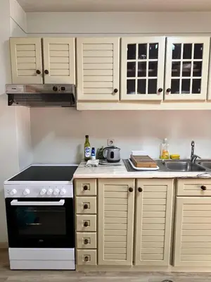a kitchen with white cabinets and a white refrigerator at Cozy Apartment Casa da Música in Porto