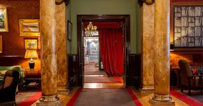 a hallway with a red curtain in a room at Grande Hotel do Porto in Porto