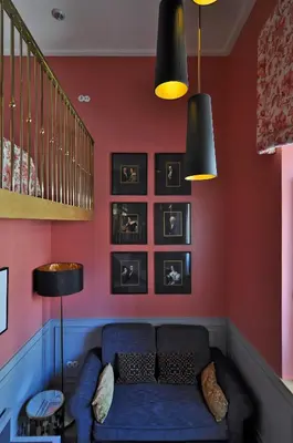 a living room with a blue couch and red walls at Grande Hotel do Porto in Porto