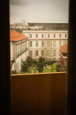 a view of a large white building from a window at CATS Porto Hostel in Porto