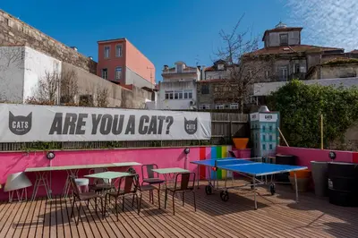 a group of tables and chairs on a patio at CATS Porto Hostel in Porto