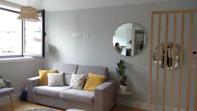 a living room with a couch and a mirror at S Bento Boutique Apartment in Porto