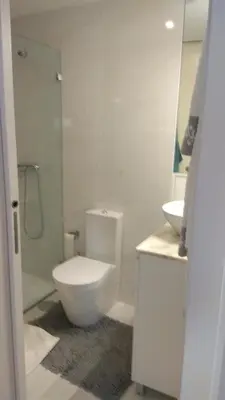 a white bathroom with a toilet and a sink at S Bento Boutique Apartment in Porto