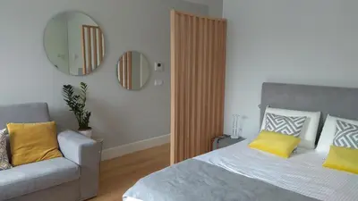 a bedroom with a bed and a chair and a mirror at S Bento Boutique Apartment in Porto