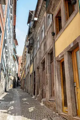 an empty street in an old city with buildings at Try Oporto - Ribeira in Porto