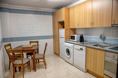 a small kitchen with a table and a microwave at Try Oporto - Ribeira in Porto