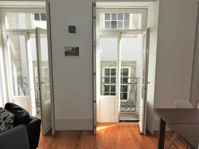 a living room with two doors and a table at Oporto Delight 2 Luxury Apartment in Historic Center Max 4p in Porto