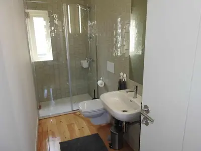 a bathroom with a sink and a toilet and a shower at Oporto Delight 2 Luxury Apartment in Historic Center Max 4p in Porto